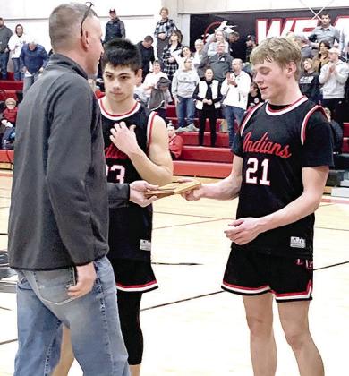 Paula Jasa/Republican PAWNEE CITY AT PIONEER – Pawnee City’s Trey Marteney (#21, right) and Anthony Kling (#23, left) accept the 4th place Pioneer Conference Basketball plaque on Saturday. See page 5 for story.
