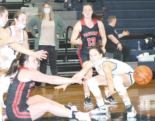 Pawnee City’s Austin Branch (left) and HTRS’ Ellie Schaardt (right) go after a loose ball as P.C.’s Larissa Tegtmeier (#13, right) and several others look on. Paula Jasa/Republican