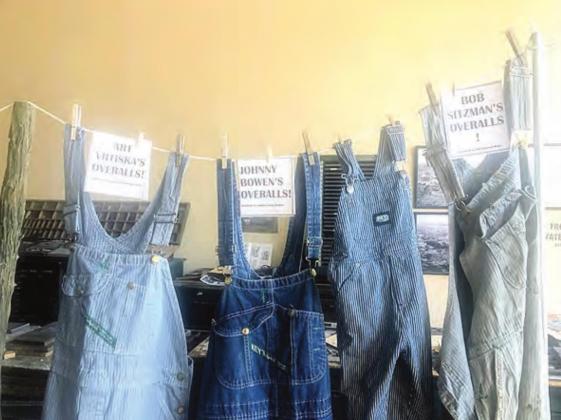 Overalls on clothesline at exhibit entrance.