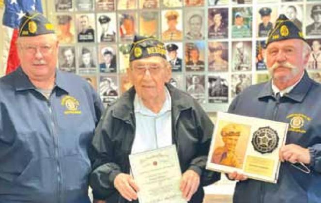 Richard Christen, middle, receives his 70-year Continuous Service certificate and a special plaque with his service picture on it from the American Legion, Brown-Hays Post 289. Left is Tom Hildebrand, Post Commander, and right is Gregg Clement, Adjutant.