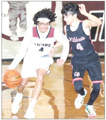 LHS’ Abel Gonzalez (#4, right) brings the ball down the floor against Cedar Bluffs in Friday night action. photo by Paula Jasa/Republican