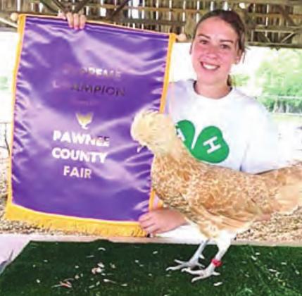 Lauren Moser with her Buff Laced Polish hen supreme champion of poultry show last year