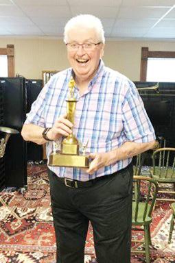 Russel Workman graduated from Table Rock in 1959 and returned to teach there in 1983. Here he is with a basketball trophy won when he was a senior. Although a high school athlete, music was his passion. He says he tells his grandchildren, “Real men sing!”