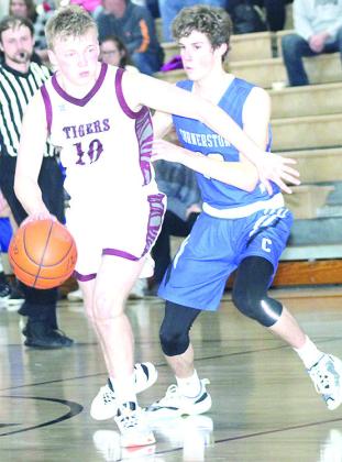 LHS’ Everett Bohling (#10, left) drives past a C.C. defender on Friday. Bohling led the Tigers with 18 points. Paula Jasa/Republican