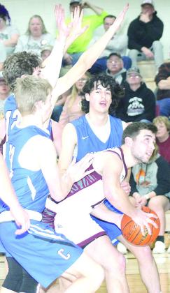 LHS’ Brady Bledsaw (center) draws a crowd down low against Cornerstone on Friday night. Paula Jasa/Republican