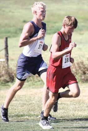 Pawnee City’s Gavin McHenry passes Freeman’s Tandon Buhr to take 31st place at the JCC Cross Country Invitational on Friday. Paula Jasa/Republican