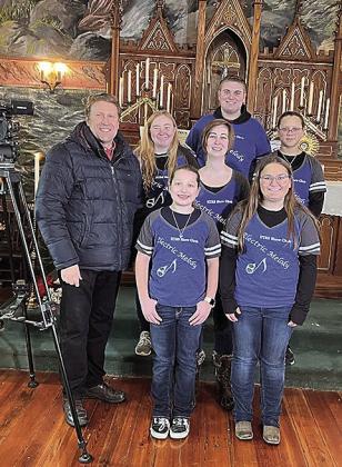 Jon Vanderford, left, of Pure Nebraska with the HTRS Show Choir in the Museum at Old St. John’s Catholic Church in Table Rock. Back row: Jake Manning. Middle Row: Alyssa Askren, teacher Katie Umland, and Brittyn Monarrez. Front row: Ellisyn Herr and Kendal Freeman.