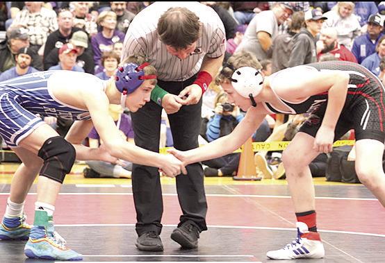 P.C.’s Luke Hunzeker (right) gets ready for his match in the 113 lb. division at Districts. Photo provided by Jamie Maloley