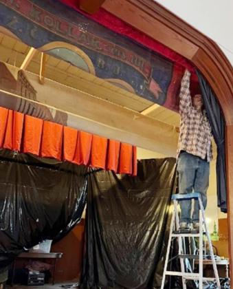 Terry Brewer working on the proscenium curtain