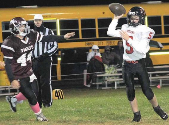 LHS’ Tristen Ray (#25, left) takes off on a run up the middle while P.C.’s Justin Pierce (#5, pictured right) goes back to pass with LHS’ Jaxon Janssen (#44, left) in pursuit. Pawnee City defeated Lewiston 59-7 on a rainy Thursday night. Paula Jasa/Republican